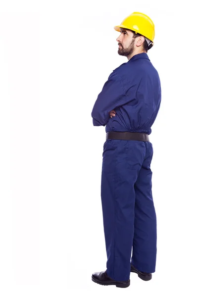 Thoughtful contractor standing with arms crossed on white backgr — Stock Photo, Image