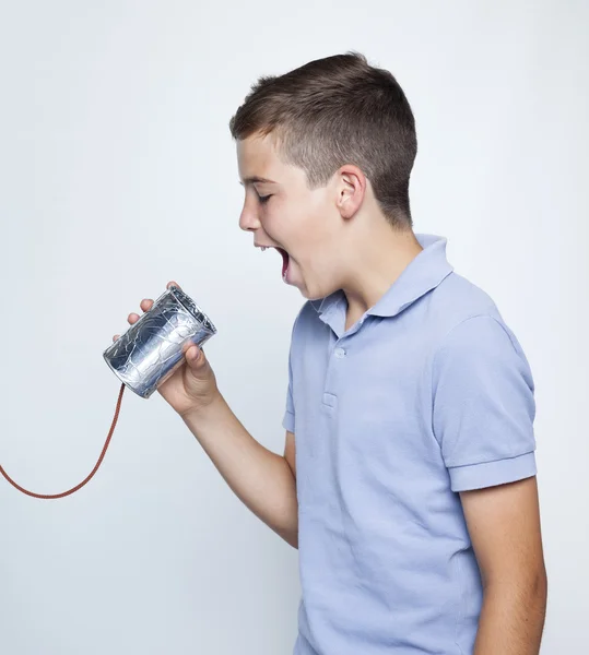Boy using a can as telephone — Stock Photo, Image
