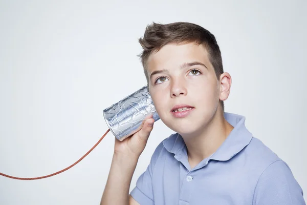 Boy using a can as telephone — Stock Photo, Image