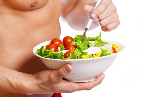 Fit man holding a bowl of fresh salad — Stock Photo, Image