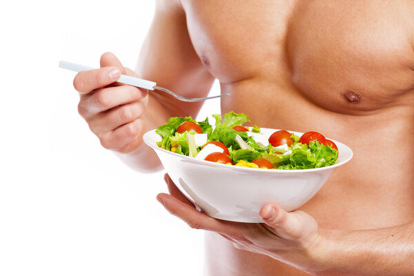 Fit man holding a bowl of  salad