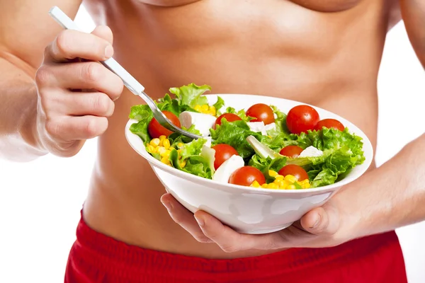 Uomo in forma che tiene una ciotola di insalata — Foto Stock