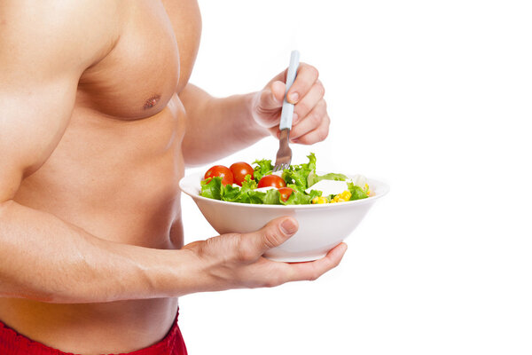 Fit man holding a bowl of  salad