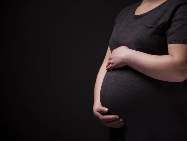 Pregnant woman holding his belly — Stock Photo, Image