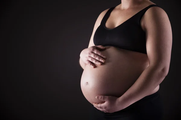 Pregnant woman holding his belly — Stock Photo, Image