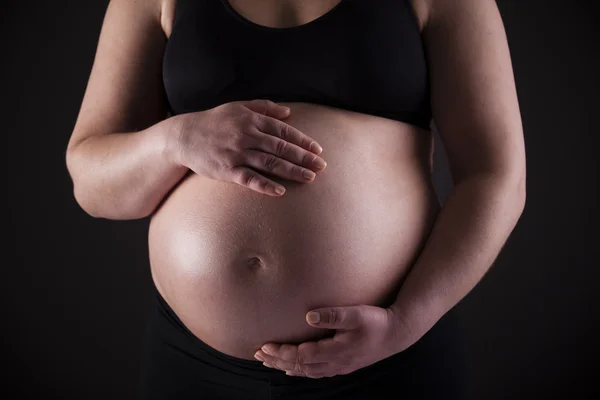 Pregnant woman holding his belly — Stock Photo, Image