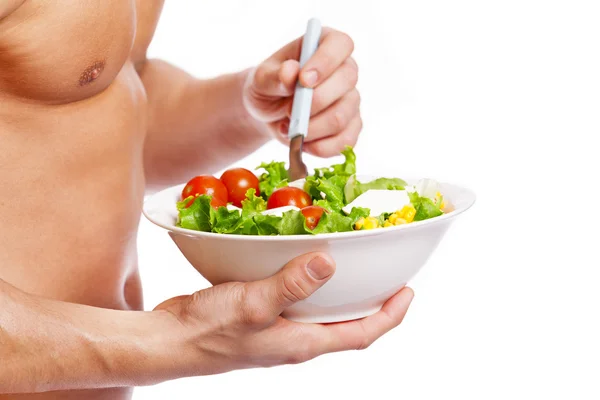 Fit man holding a bowl of fresh salad — Stock Photo, Image