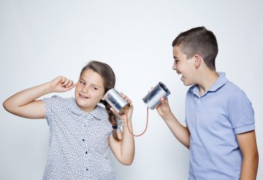 Kids using a can as telephone