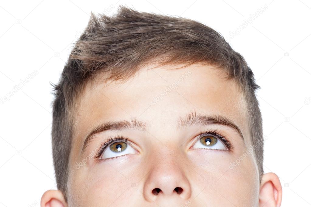 Closeup of teenager boy looking up