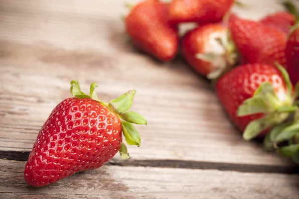 Strawberries closeup on wooden background — Stock Photo, Image