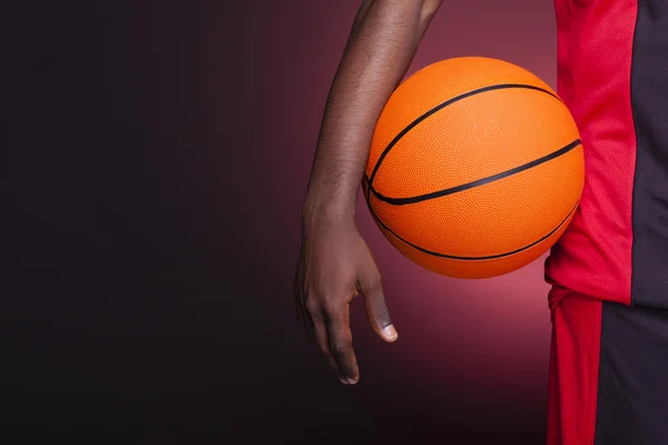 Detail of a basketball player holding a ball — Stock Photo, Image