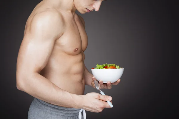 Fitness homme tenant un bol de salade fraîche — Photo