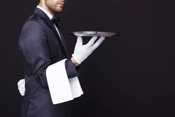 Waiter holding an empty silver tray — Stock Photo, Image