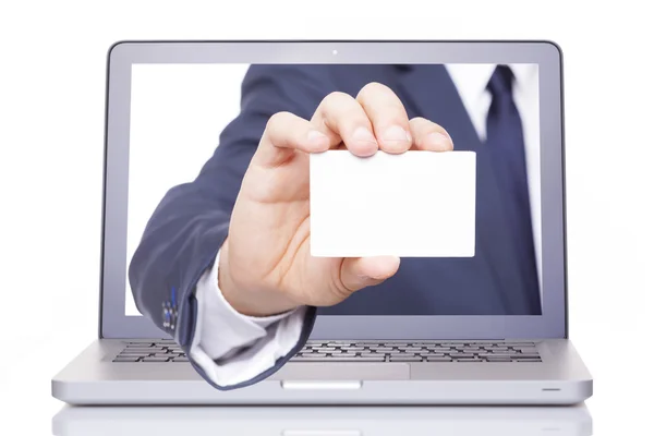 Business man hand giving a business card through a laptop — Stock Photo, Image