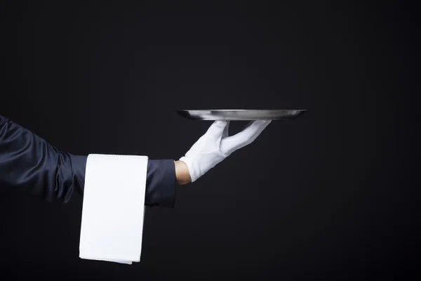 Waiter hand holding a tray — Stock Photo, Image