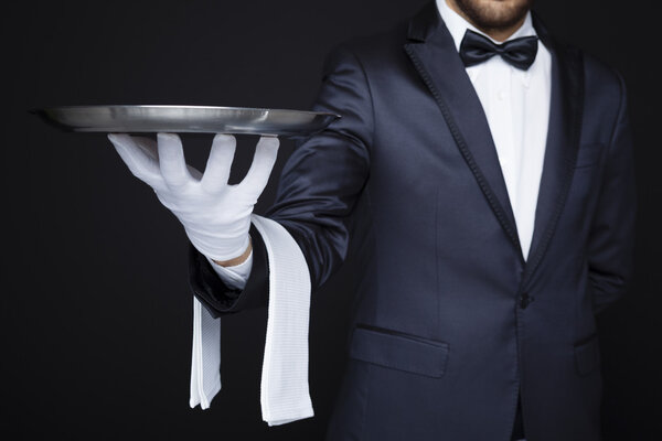 Waiter holding an empty silver tray