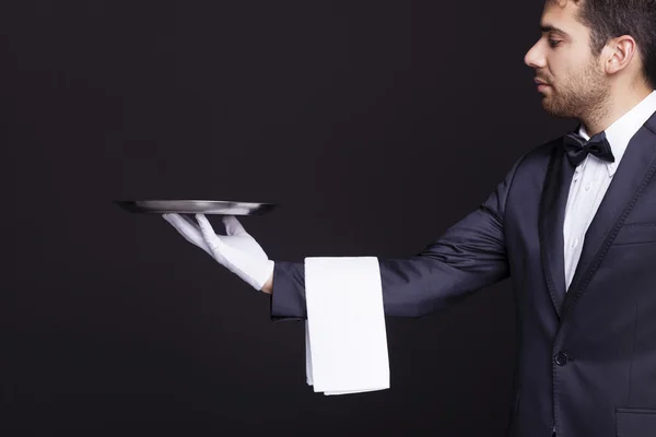 Waiter holding an empty silver tray — Stock Photo, Image