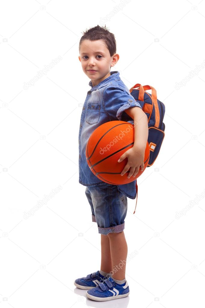 School boy posing with a basketball
