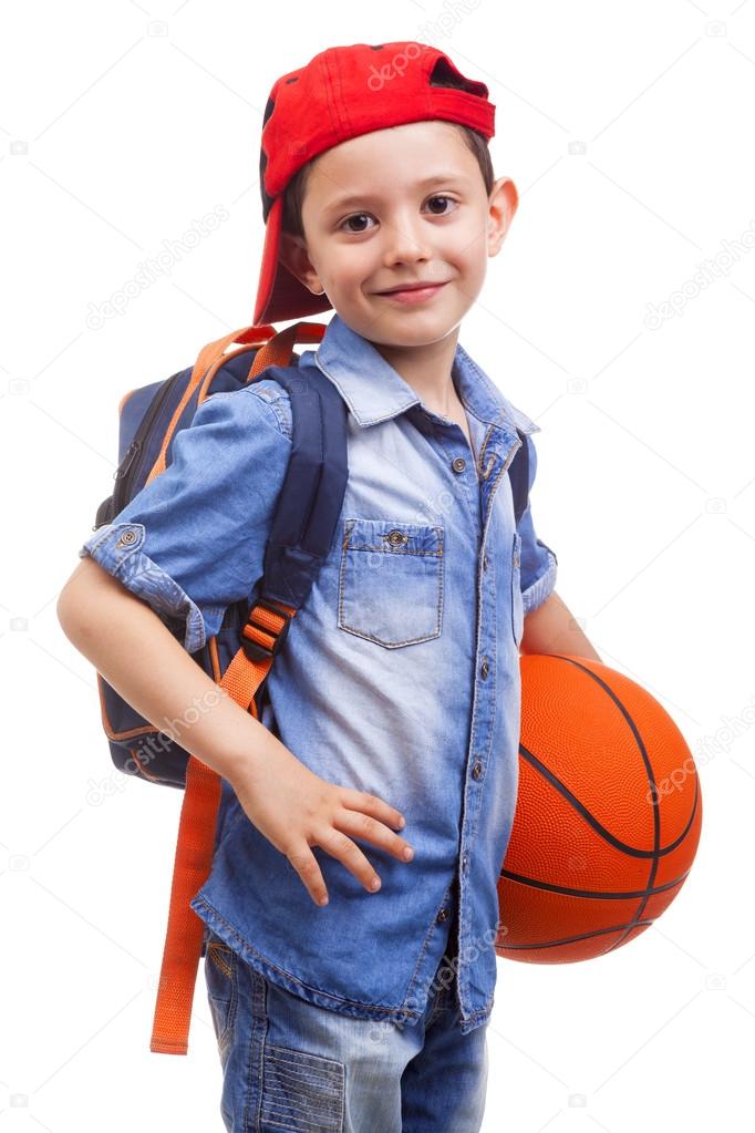 school boy holding a basketball