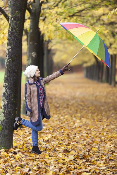 Woman holding a multicolor umbrella — Stock Photo, Image