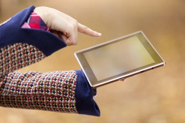 Woman finger pointing to a tablet