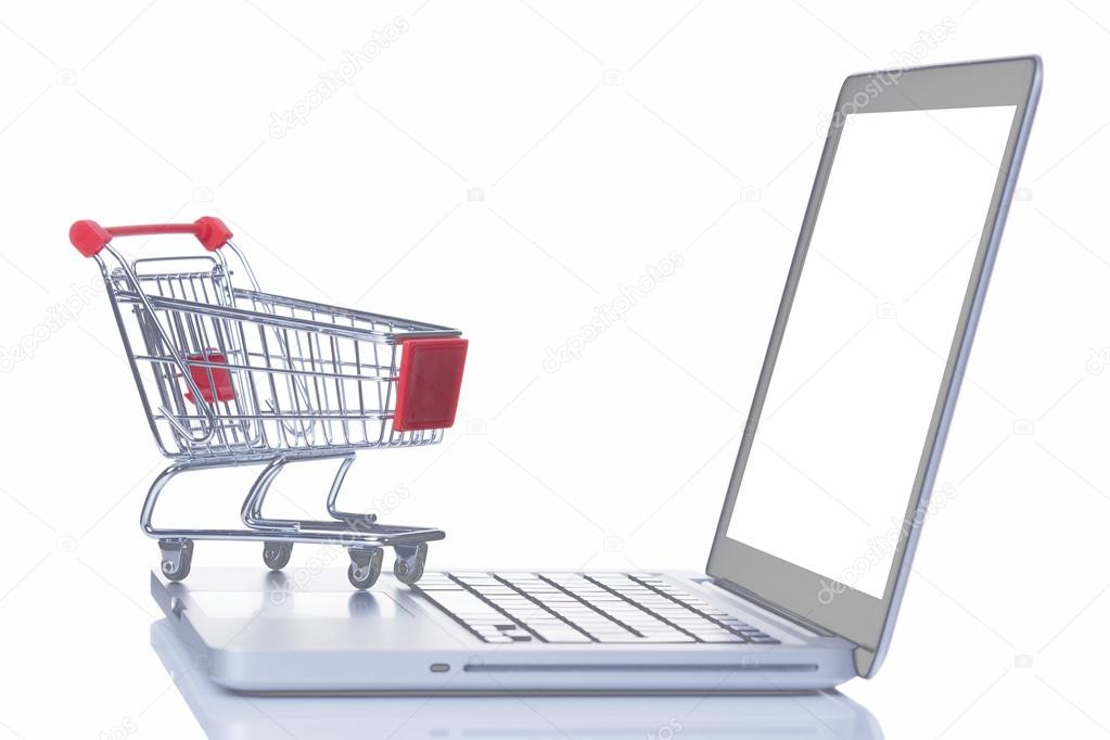 Shopping cart over a laptop computer