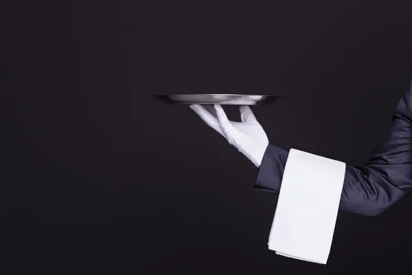 Waiter hand holding an empty silver tray — Stock Photo, Image