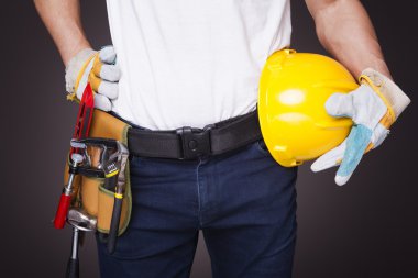 İşçi toolbelt ve kask ile
