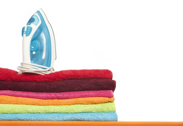 Ironing board with colorful towels — Stock Photo, Image