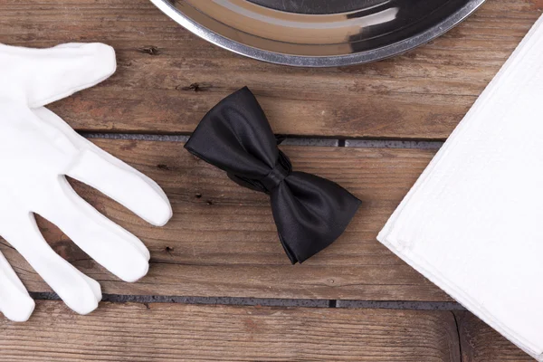 Waiter tray, bow tie, gloves and a napkin — Stock Photo, Image