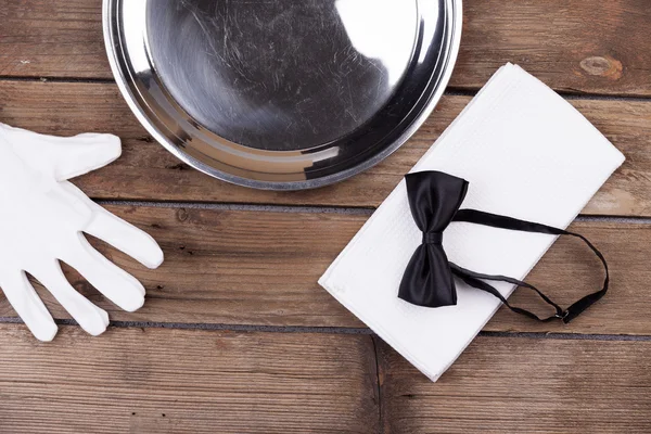 waiter tray, bow tie, gloves and a napkin