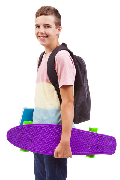 school boy holding a skateboard and notebooks