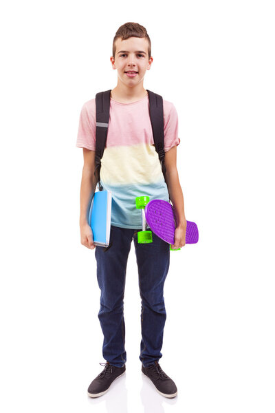 school boy holding a skateboard and notebooks