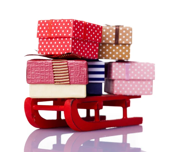 Red sled full of gift boxes — Stock Photo, Image