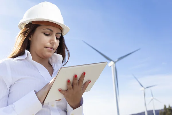 Environmental engineer with a tablet computer at wind farm — Stock Photo, Image