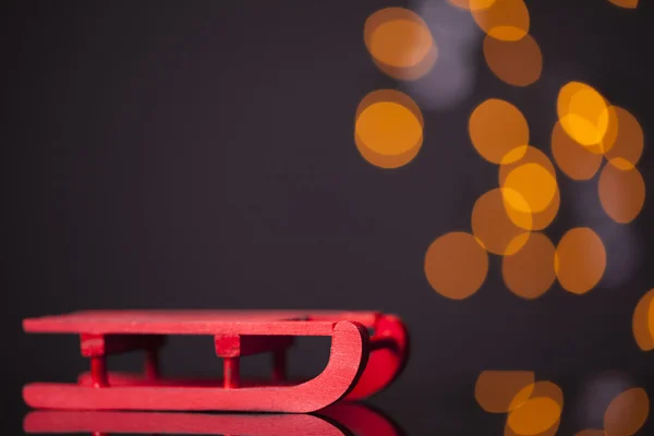 Red sledge on dark background — Stock Photo, Image
