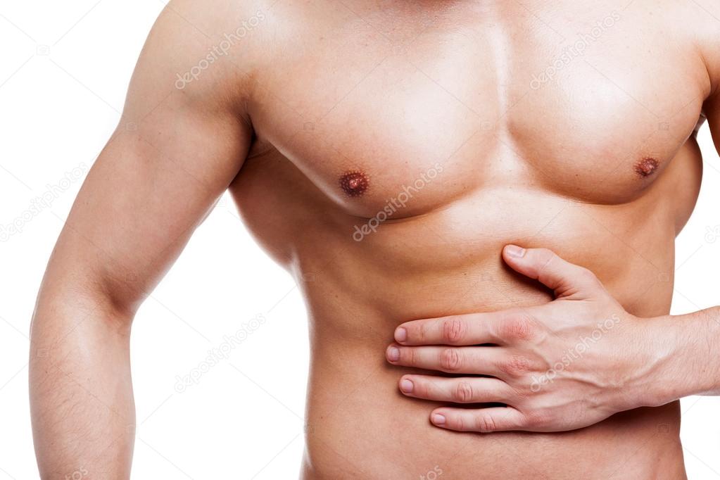 Muscled man holding his belly in pain