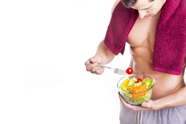 Fit young man holding a bowl of salad — Stock Photo, Image