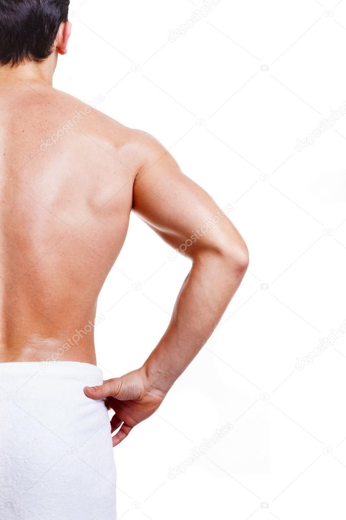 Rear view of a muscled man in towel