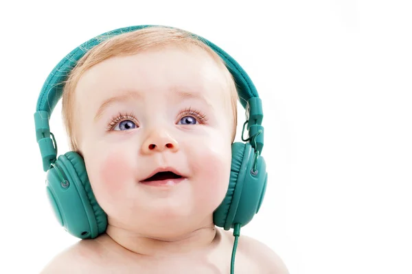 Smiling baby with headphones listening to music, isolated on whi — Stock Photo, Image