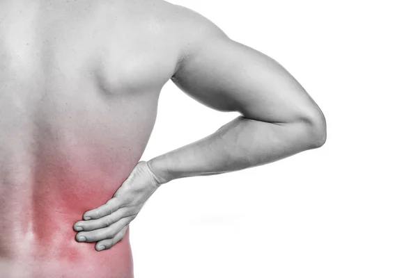 Muscular man holding his back in pain — Stock Photo, Image