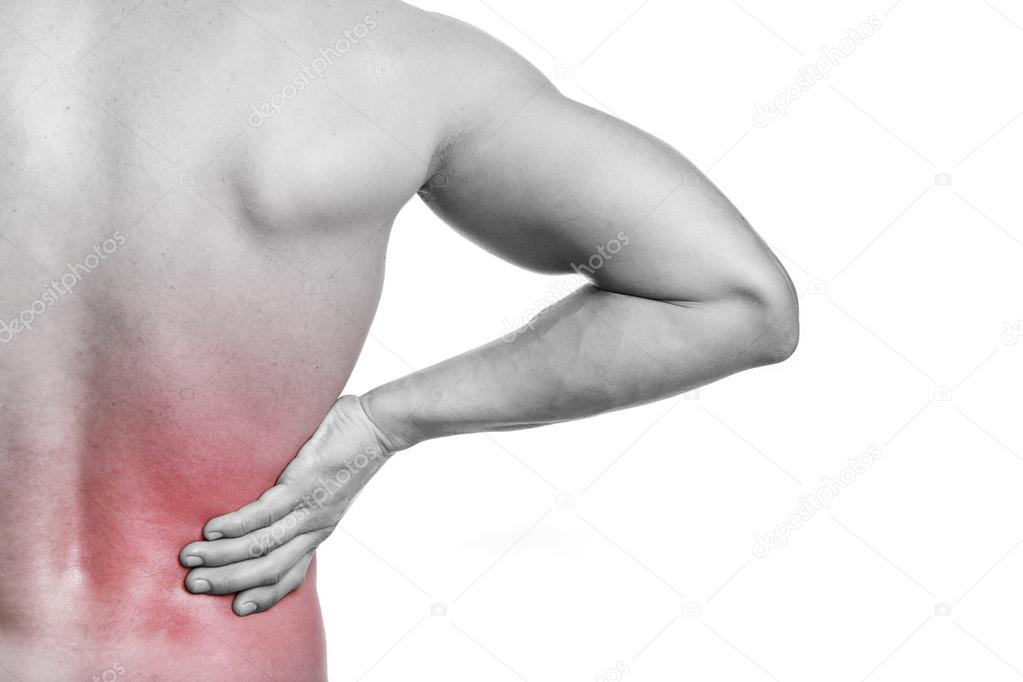 Muscular man holding his back in pain