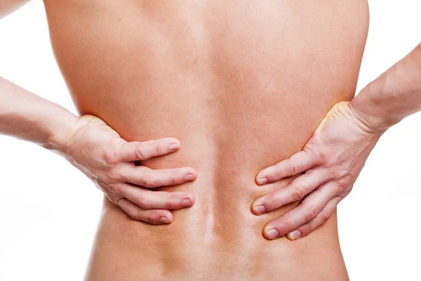 Young man holding his back in pain — Stock Photo, Image