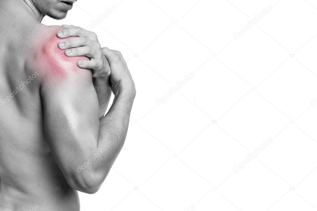 Fit man holding his shoulder in pain
