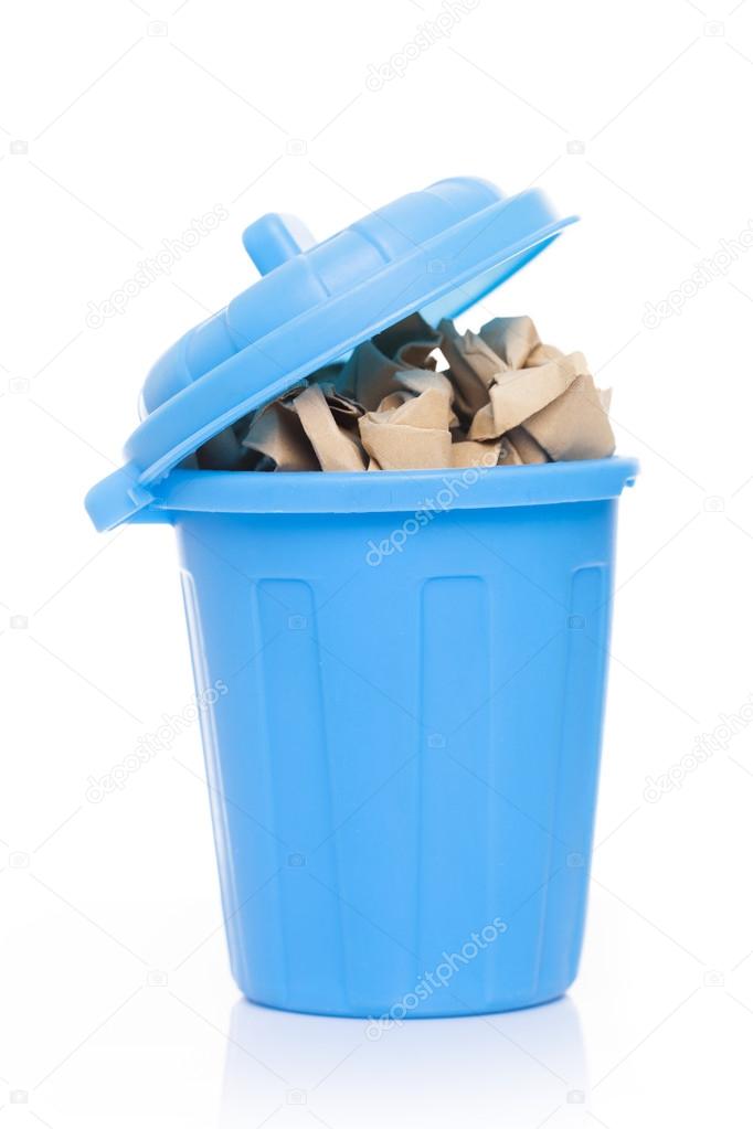 A blue bin full of crumpled paper