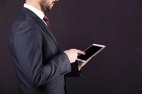 Businessman pointing to his digital tablet — Stock Photo, Image