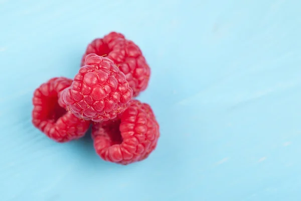 Raspberries on a wooden table — Stock Photo, Image