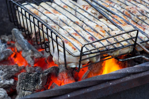 Chiken on the grill, fiery coals. — Stock Photo, Image