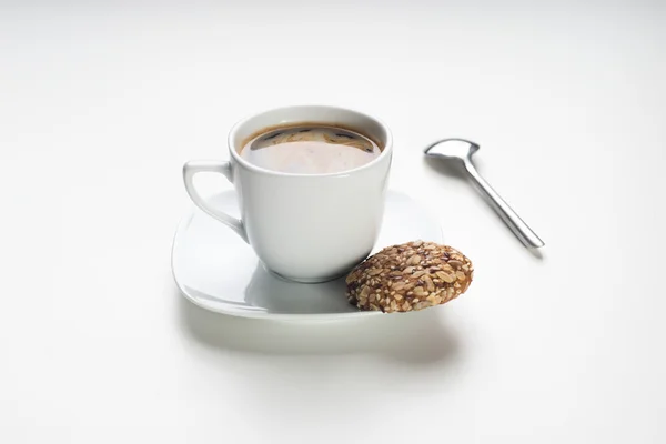 Cup of hot coffee with cookies on white background — Stock Photo, Image