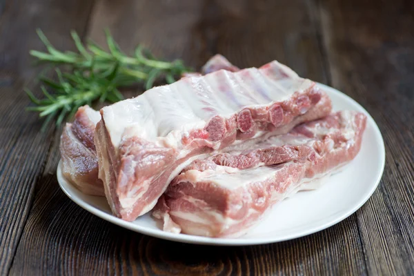 Gros plan Viande de côtes de porc crue sur un plat blanc — Photo